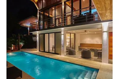 a house with a swimming pool in front of it at Casa Canopy in Nosara