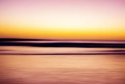 a blurry picture of the ocean at sunset at Casa Coastin in Nosara
