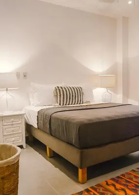 a bedroom with a large bed and a nightstand and a bed sidx sidx sidx at Casa Coastin in Nosara