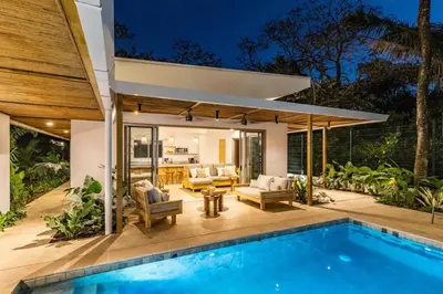 an outdoor patio with a swimming pool and a house at Green house 1&2 Green Complex in Nosara