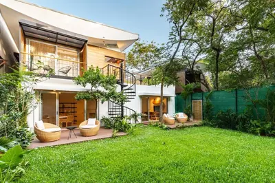 a house with a yard with chairs and a fence at Green house 1&2 Green Complex in Nosara