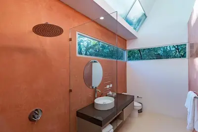 a bathroom with a sink and a mirror at Green house 1&2 Green Complex in Nosara