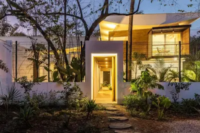a home with a hallway leading to the front door at Green house 1&2 Green Complex in Nosara
