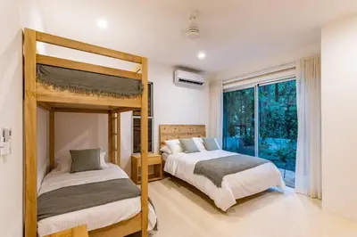 a bedroom with two bunk beds and a window at Green house 1&2 Green Complex in Nosara