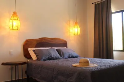 a bedroom with a bed with a hat on it at Hotel Huacas in Huacas