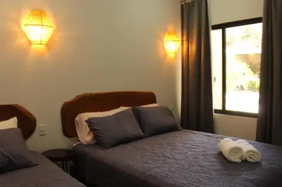a bedroom with two beds with towels on the bed at Hotel Huacas in Huacas