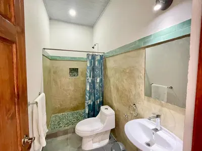 a bathroom with a toilet and a sink at Hotel Huacas in Huacas