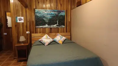 a bedroom with a bed with two pillows on it at Cala Lodge in Monteverde Costa Rica