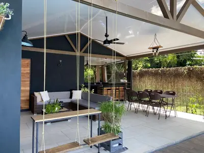 a pavilion with a table and chairs on a patio at Alojamiento con piscina in Aguas Zarcas
