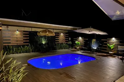 a blue hot tub on a patio at night at Alojamiento con piscina in Aguas Zarcas