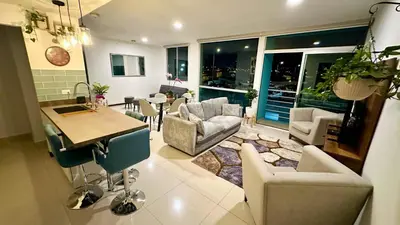 a kitchen and living room with a table and chairs at Modern, large and equipped in San José