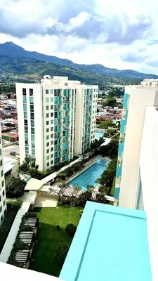 a view from the balcony of a building with a swimming pool at Modern, large and equipped in San José