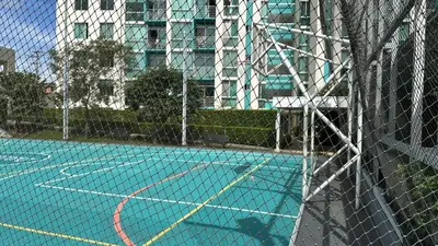 a tennis court with a net in front of a building at Modern, large and equipped in San José