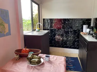 a kitchen with a table with a bowl of fruit on it at Casita Campos in Sarapiquí