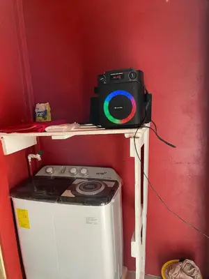 a camera sitting on a shelf next to a washing machine at Casita Campos in Sarapiquí