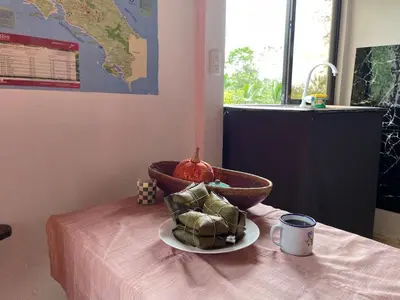 a bowl of food sitting on a table with a cup at Casita Campos in Sarapiquí