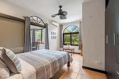 a bedroom with a bed and a ceiling fan at Suite 2 Howler - Beach & Pool Condo with 2 BR in Brasilito
