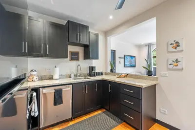 a kitchen with black cabinets and a counter top at Suite 2 Howler - Beach & Pool Condo with 2 BR in Brasilito