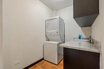 a small kitchen with a refrigerator and a counter at Suite 2 Howler - Beach & Pool Condo with 2 BR in Brasilito