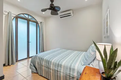 a bedroom with a bed and a ceiling fan at Suite 2 Howler - Beach & Pool Condo with 2 BR in Brasilito