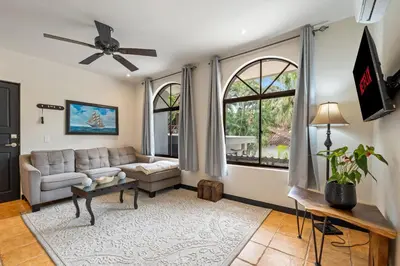 a living room with a couch and a tv at Suite 2 Howler - Beach & Pool Condo with 2 BR in Brasilito