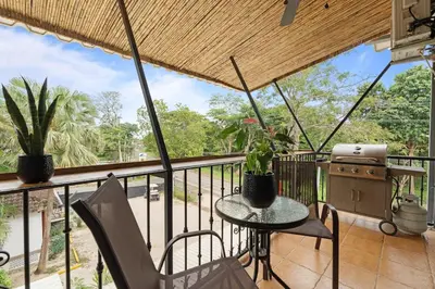 a balcony with a table and chairs and a view at Suite 4 Sloth - Pool&Beach 3 BR Condo in Brasilito