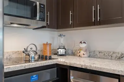 a kitchen with a counter top with a microwave at Suite 4 Sloth - Pool&Beach 3 BR Condo in Brasilito