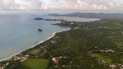 an aerial view of an island in a body of water at Suite 4 Sloth - Pool&Beach 3 BR Condo in Brasilito