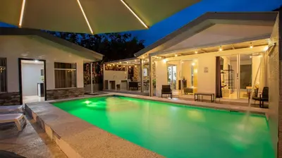 a swimming pool in front of a house at Villa Diriá La Fortuna - Downtown Home in Fortuna