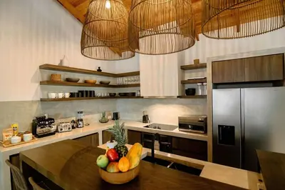 a kitchen with a table with a bowl of fruit on it at Rincon Escondido in Nosara