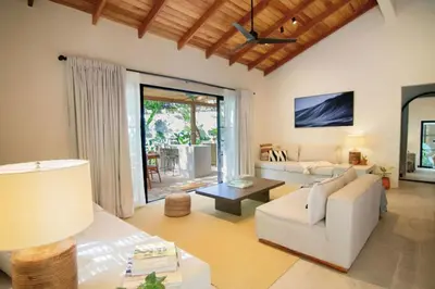 a living room with a white couch and a table at Rincon Escondido in Nosara