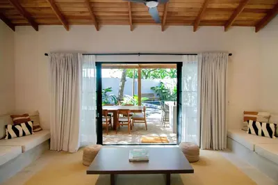 a living room with a table and a patio at Rincon Escondido in Nosara