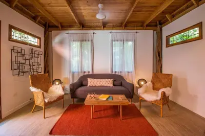 a living room with a couch and two chairs at Casa Jose in Nosara