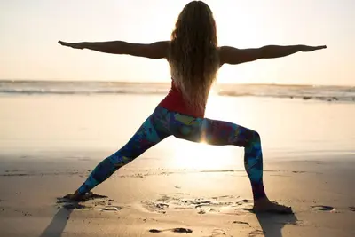 a woman doing yoga on the beach at Casa Jose in Nosara