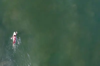 a person riding a wave on a surfboard in the water at Casa Jose in Nosara