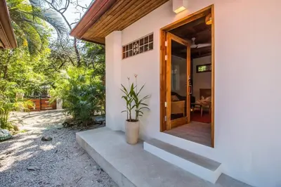 a front door of a house with a potted plant at Casa Jose in Nosara