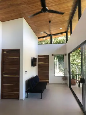 a living room with a ceiling fan and a couch at Casa Manzu in Nosara