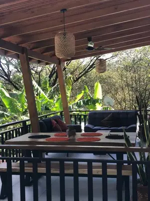 a table under a pergola on a patio at Casa Manzu in Nosara
