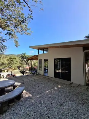 a building with a picnic table in front of it at Casa Manzu in Nosara
