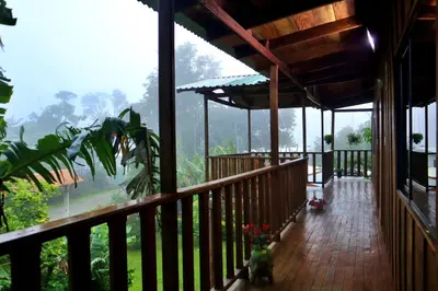 a porch of a house with a view of a mountain at VA Logde in Monteverde Costa Rica