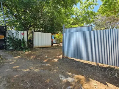 a white fence with a gate in a yard at Casa del Sol Playa Avellanas in San José Pinilla