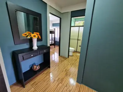 a hallway with a vase of flowers and a mirror at Casa del Sol Playa Avellanas in San José Pinilla