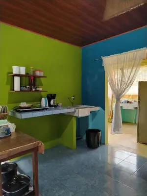 a kitchen with green and blue walls and a counter at Casa Marina in Pedregal