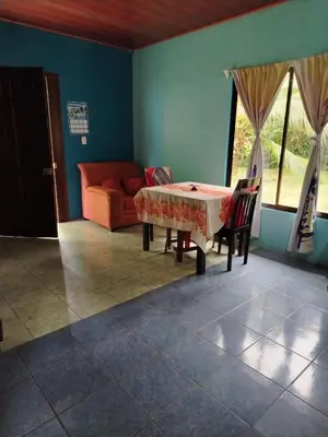 a living room with a table and a couch at Casa Marina in Pedregal