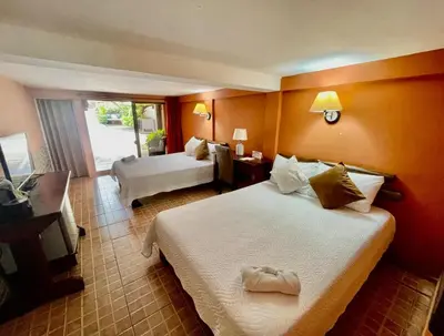 a hotel room with a bed and a living room at Hotel Mar y Mar in Puntarenas
