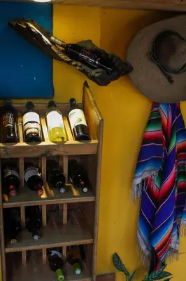 a bunch of bottles of wine on a wall at Hotel Mar y Mar in Puntarenas