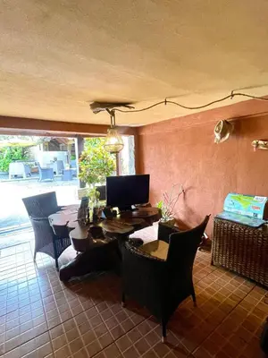 a room with a desk with chairs and a computer at Hotel Mar y Mar in Puntarenas