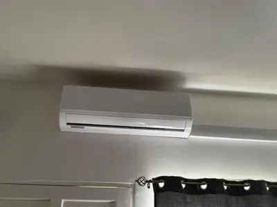 a bathroom with a air conditioner hanging from the ceiling at Thompson House in Orotina