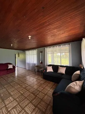 a living room with couches and a wooden ceiling at Finca Marbella in San Ramón