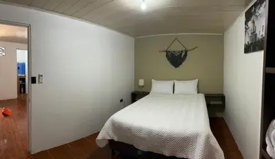 a bedroom with a white bed in a room at Perezoso View Apartment in Guápiles